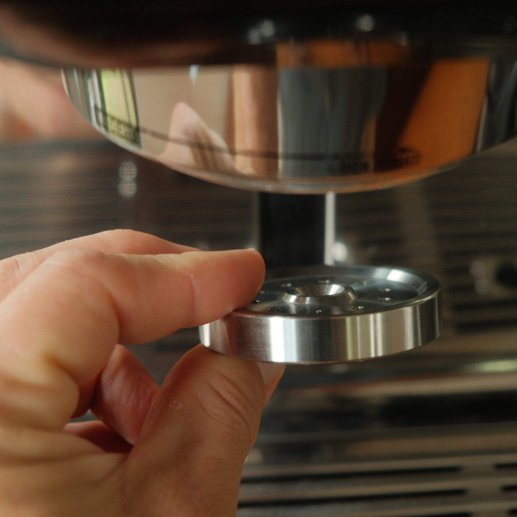 Puck screen resting on a coffee puck in an espresso portafilter