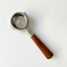 画像をギャラリービューアに読み込む, A bottomless portafilter with a 51mm size, featuring a two-ear design, almond-colored wooden handle, and stainless steel body.
